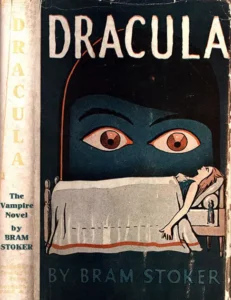 1928 Grosset & Dunlap dust jacket for Bram Stoker's Dracula: a green masked face with red eyes looming over a woman lying on a table