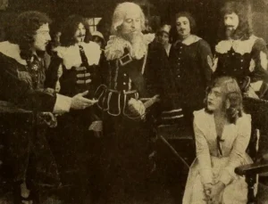 Mae Murray seated among men in seventeenth-century costume in a scene from To Have and to Hold (1916)