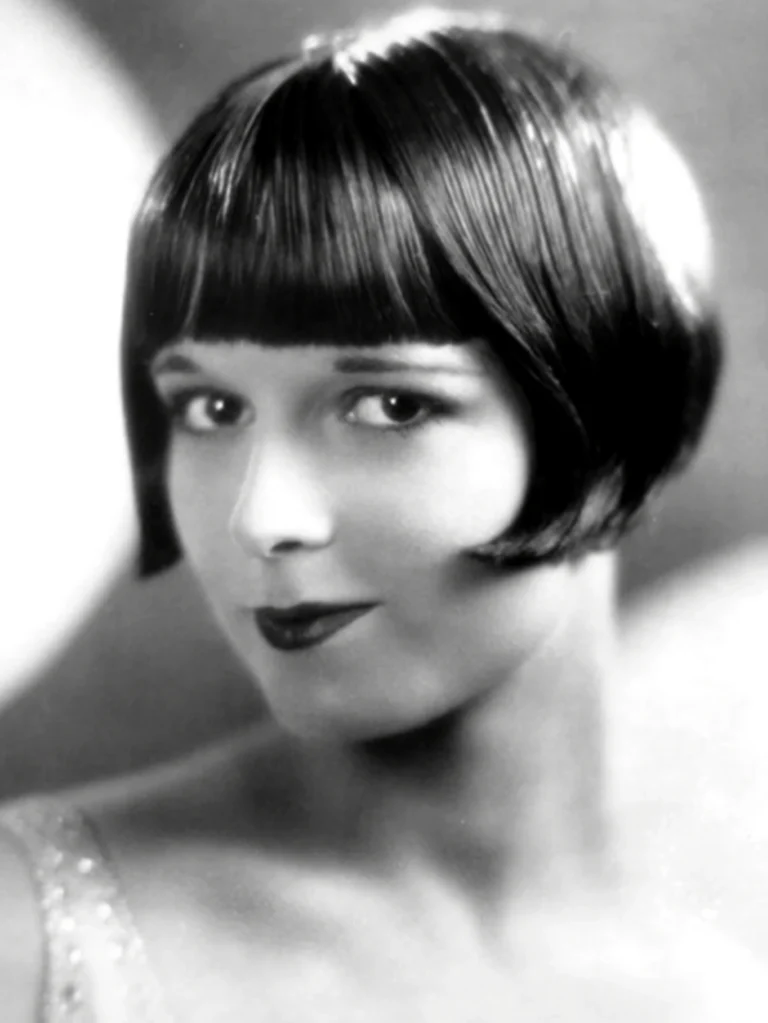 Louise Brooks in a studio portrait of about 1926, wearing the sharply cut dark bob that became the most recognizable haircut in American silent film.