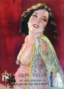 Color poster portrait of Lupe Velez in a pink gown and sheer iridescent shawl, lettered Lupe Velez as she appears in Lady of the Pavements